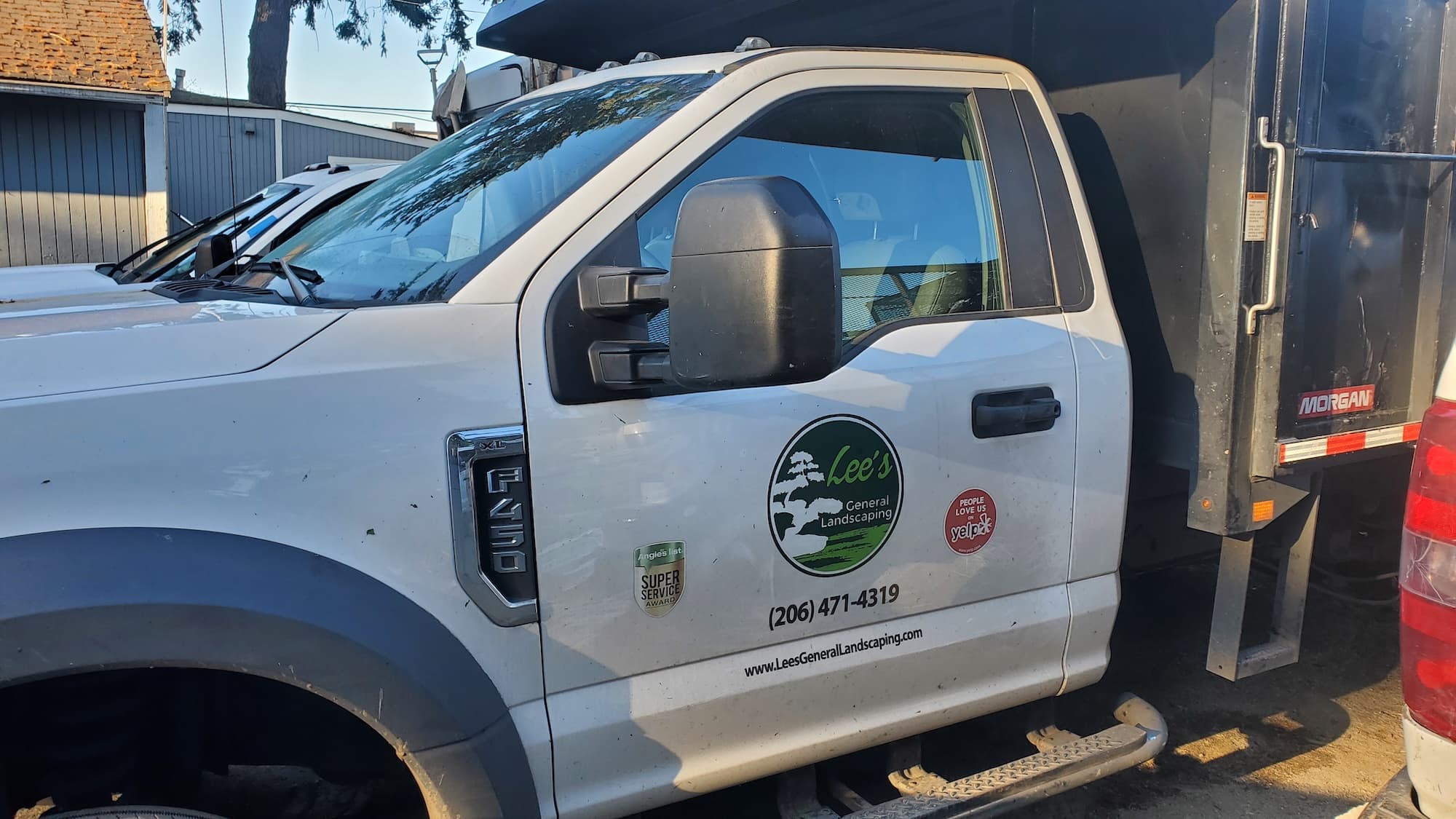 Lee's General Landscaping truck performing yard clean-up